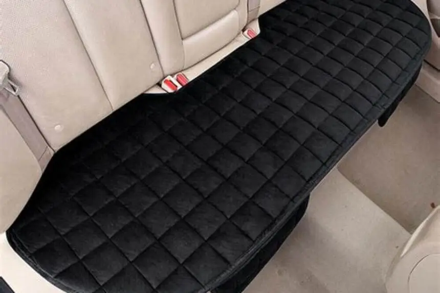 Narrow car rear seat with baby car seat and seat protector mat fitted
